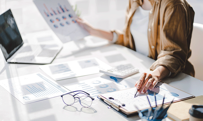 Employee reviewing financial documents on a desk